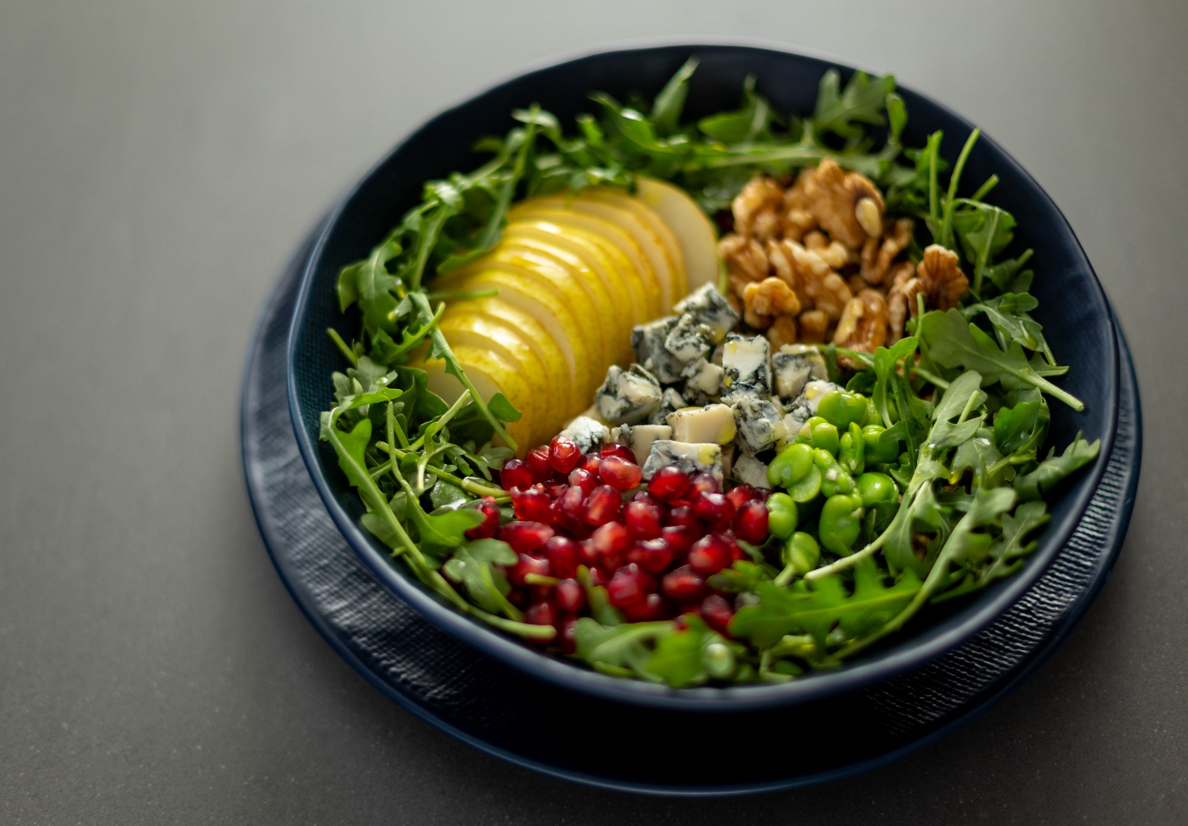 Pear & Gorgonzola Salad with Arugula and Pomegranate served